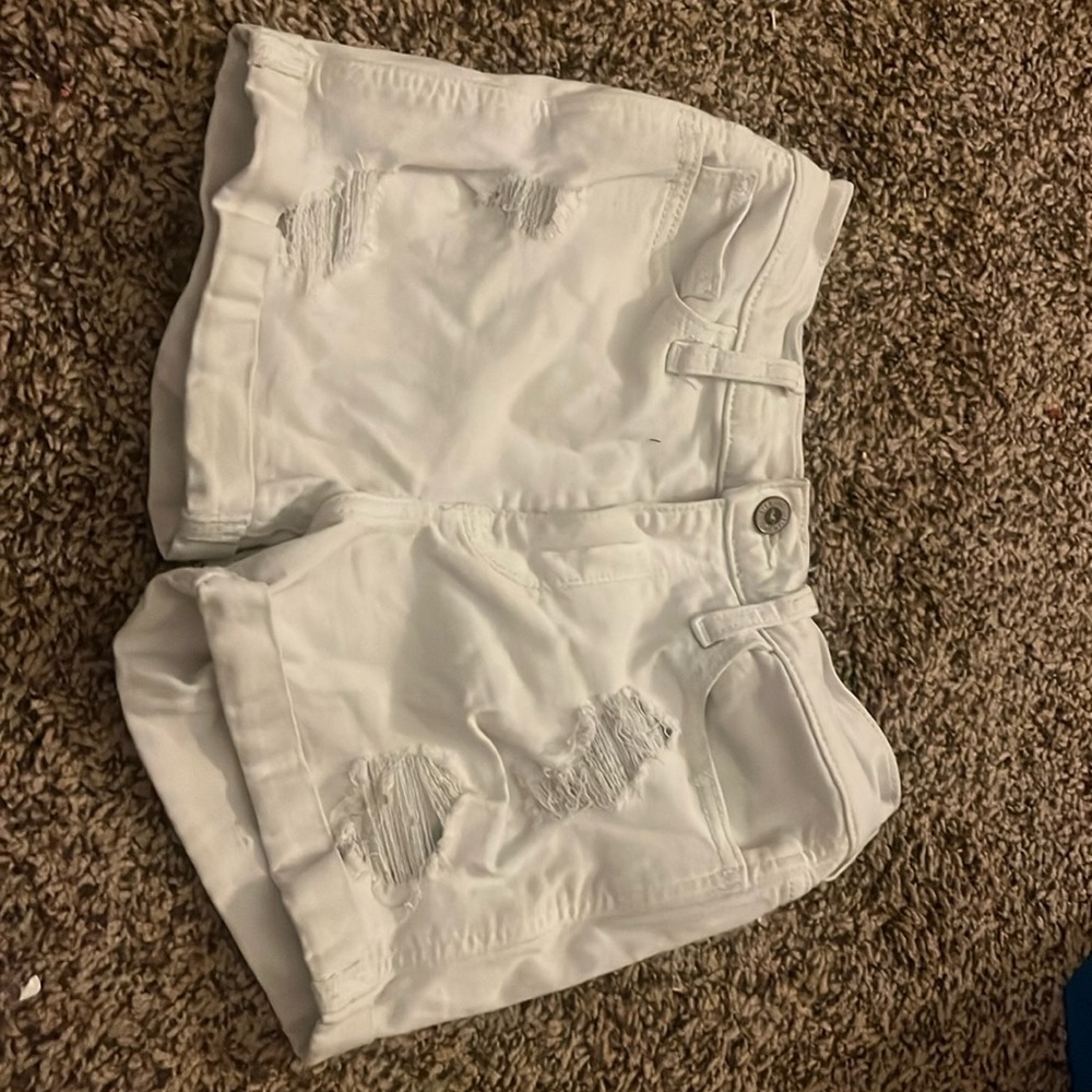 White Hollister shorts rips in the legs size 0 W24, zipper and button works